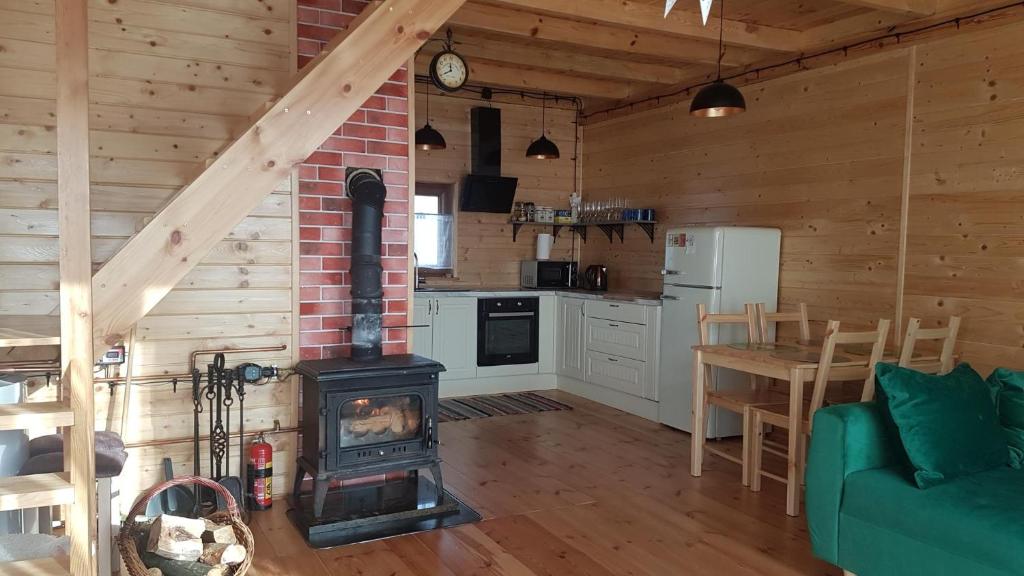 a living room with a wood stove in a cabin at Zamieszkaj na wsi blisko Warszawy in Borucza