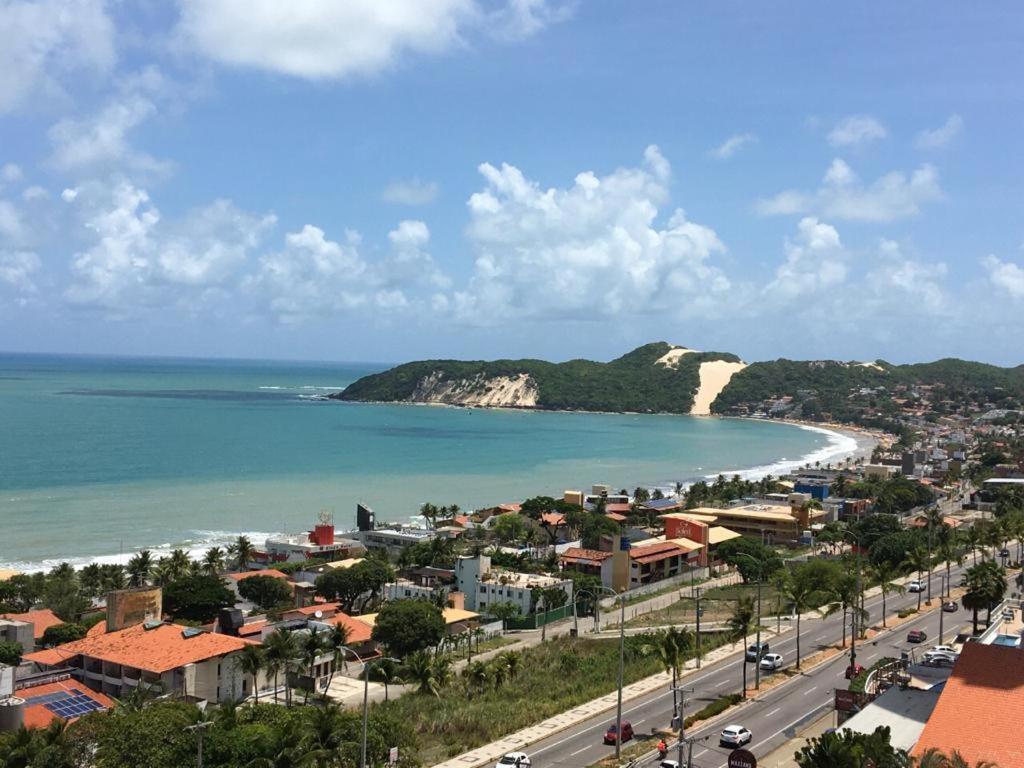 a view of a city and a beach with the ocean at Ponta Negra Flat 811 in Natal