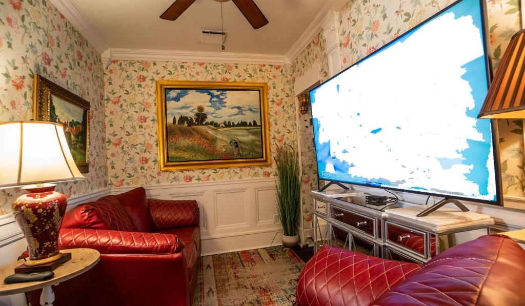 a living room with a large flat screen tv at Casablanca Inn on the Bay in Saint Augustine