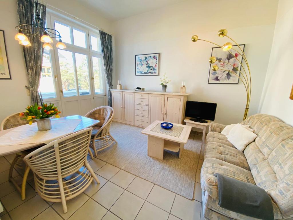 een woonkamer met een bank en een tafel bij Villa Caprivi - Ferienwohnung 7 in Heringsdorf