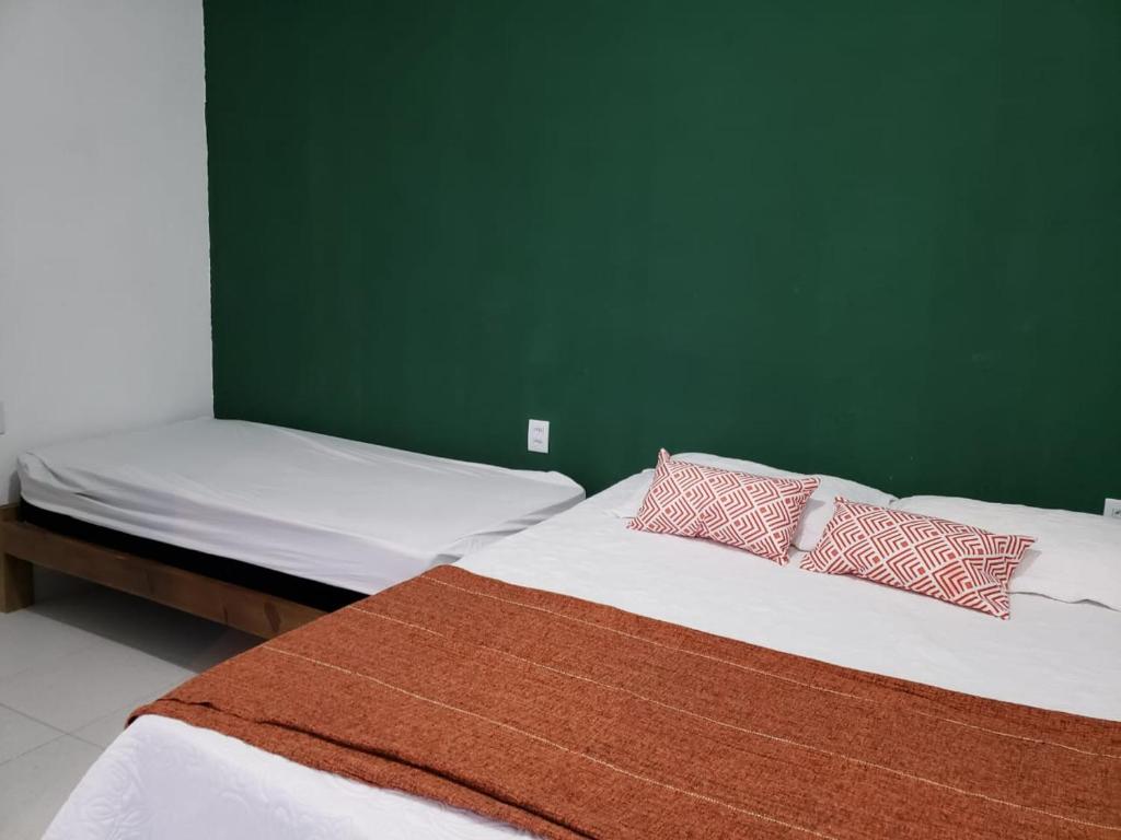 מיטה או מיטות בחדר ב-Casa no Barro Preto - Vila da Praia, Iguape - Ceará