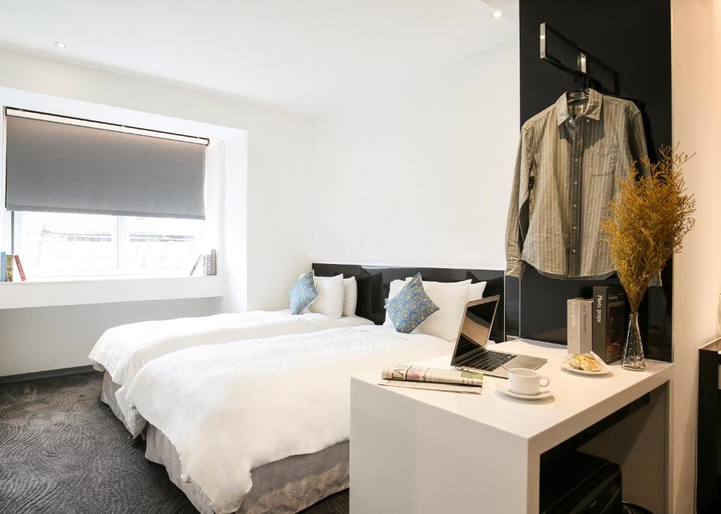 Postel nebo postele na pokoji v ubytování CityInn Hotel Plus - Taichung Station Branch