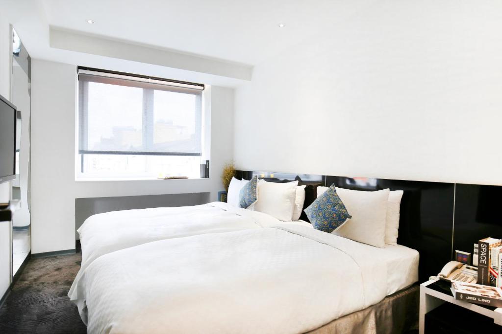 Postel nebo postele na pokoji v ubytování CityInn Hotel Plus - Taichung Station Branch