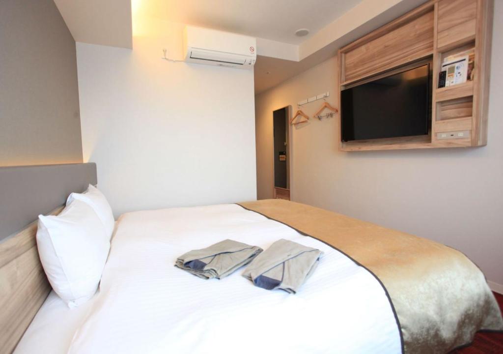 Postel nebo postele na pokoji v ubytování Urban Hotel Kyoto Gojo Premium