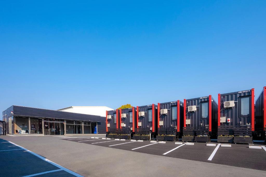 a row of train cars parked in a parking lot at HOTEL R9 The Yard Narita Kukou Nishi in Narita