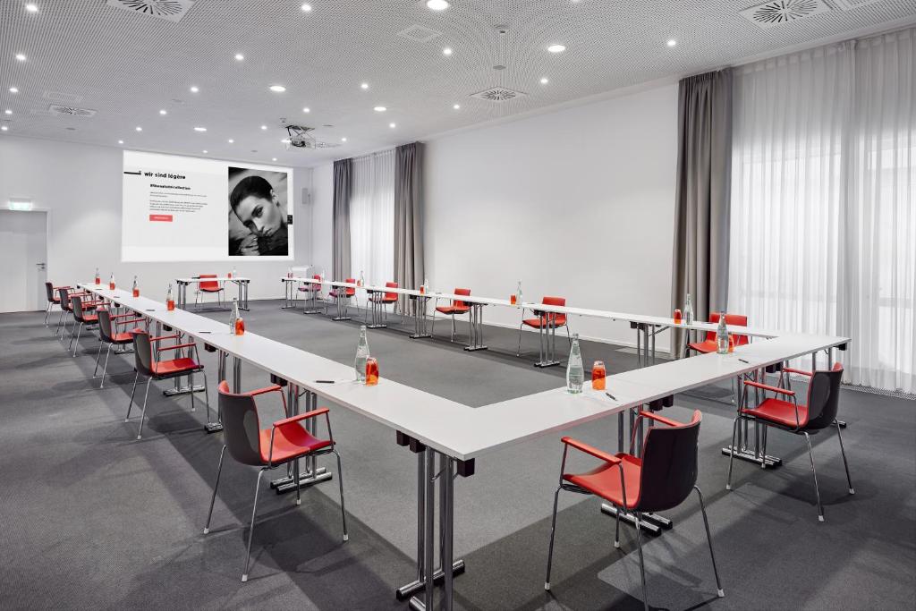a conference room with a long table and chairs at LÉGÈRE HOTEL Luxembourg in Luxembourg