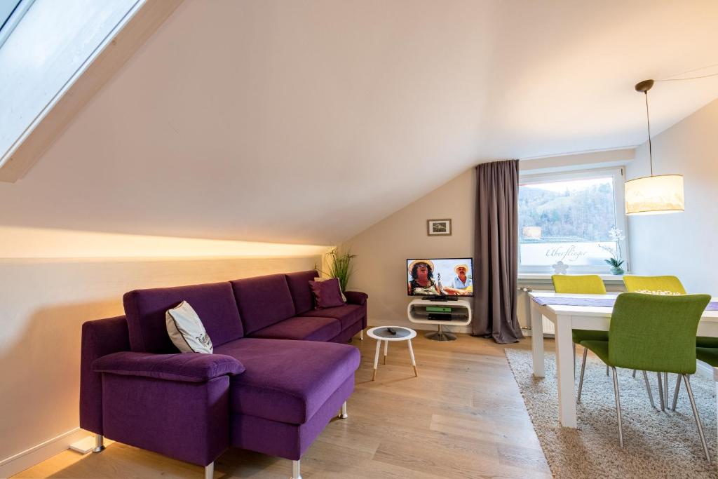 a living room with a purple couch and a table at Überflieger in Garmisch-Partenkirchen