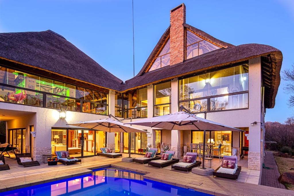 an exterior view of a house with a swimming pool at Vaal River YOLO Spaces - Vaal River Bush Lodge in Sasolburg