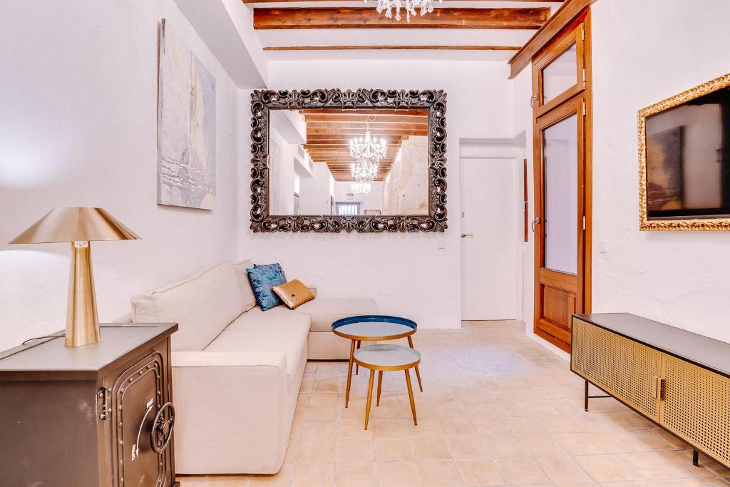 a living room with a white couch and a table at Vintage Palma Palace Apartments TI in Palma de Mallorca