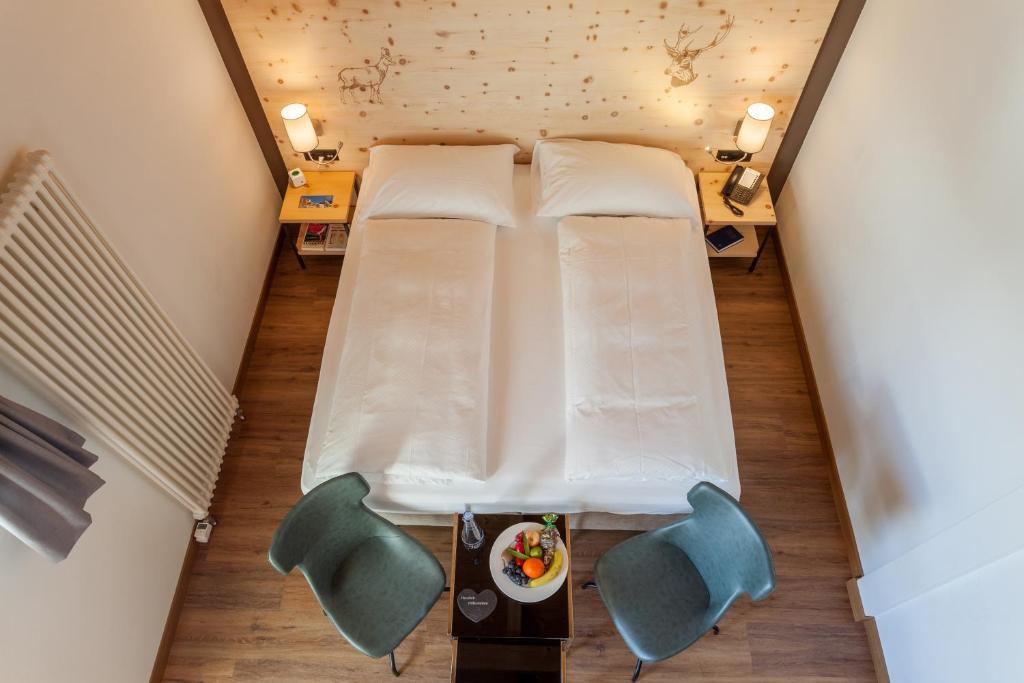 Postel nebo postele na pokoji v ubytování Hotel Waldhaus am See