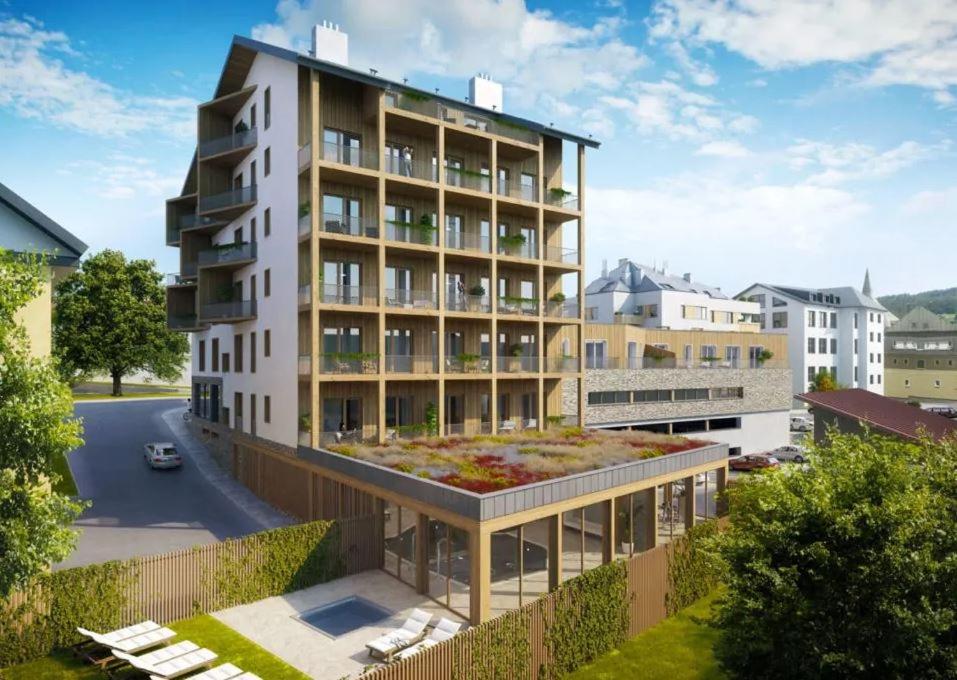 an apartment building with a green roof at Apartment No25 Residence Javor in Železná Ruda