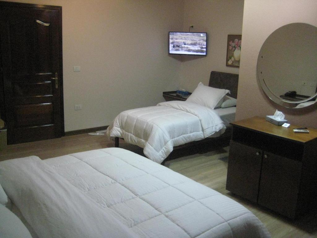 Postel nebo postele na pokoji v ubytování Drini Hotel