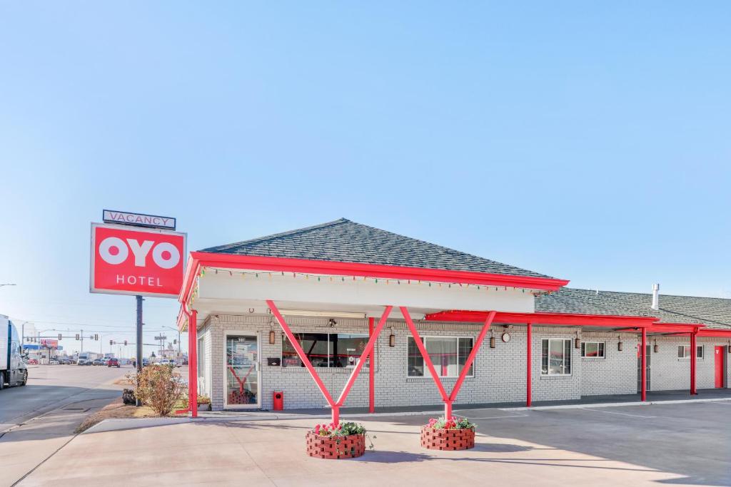a mobil gas station with a sign in front of it at OYO Hotel Liberal, Kansas in Liberal