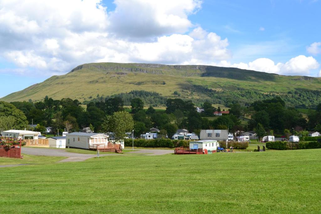 a small town with a mountain range at Campsie Glen Holiday Park in Fintry