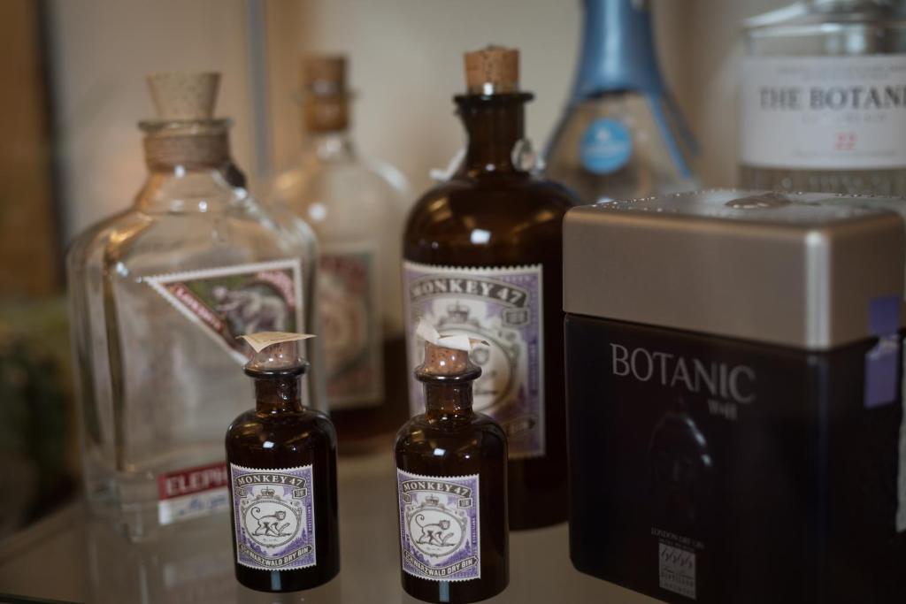 two bottles of alcohol sitting on a counter with other bottles at Hotel Albatros Varigotti in Varigotti