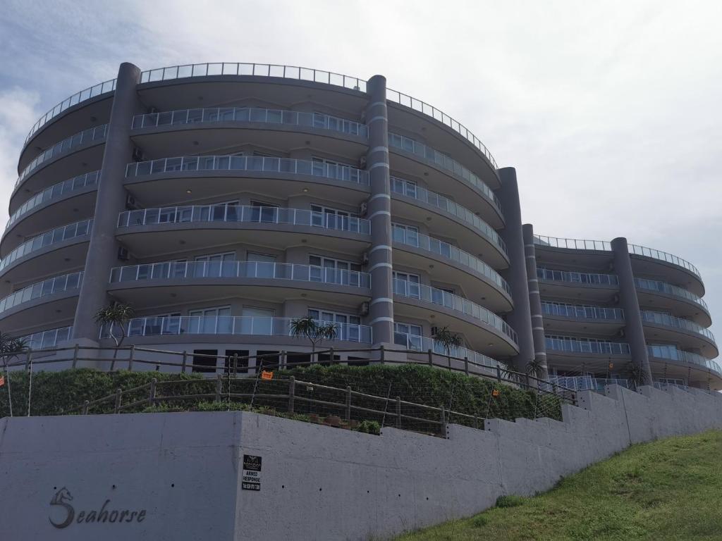 a large building with a fence in front of it at Seahorse unit 4 in Scottburgh