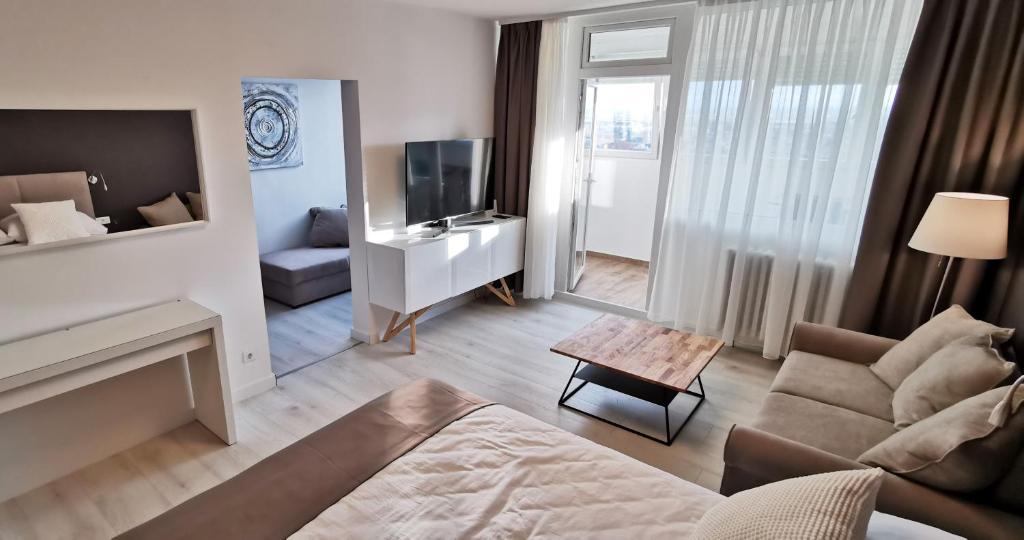 a living room with a couch and a television at Sky 17 Lux apartman in Zagreb