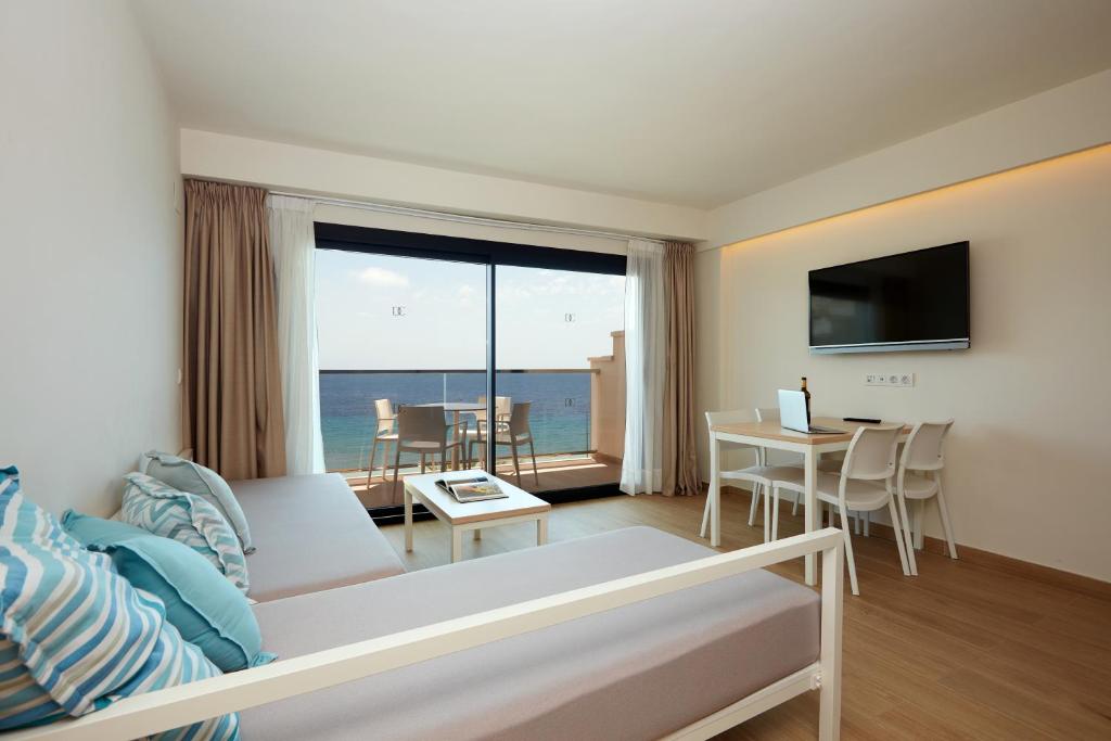 a living room with a couch and a view of the ocean at Don Cesar Boutique Apartments in Benidorm