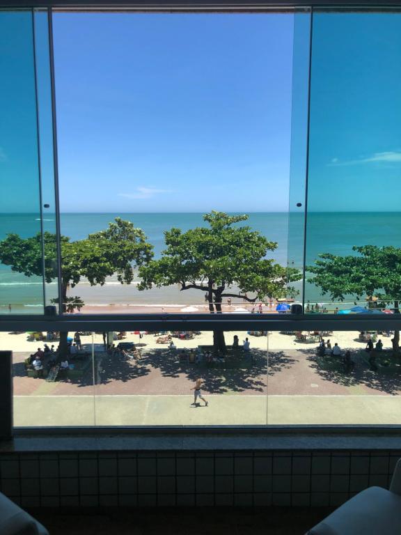 a view of the beach from the window of a building at Apartamento de frente para o mar in Guarapari