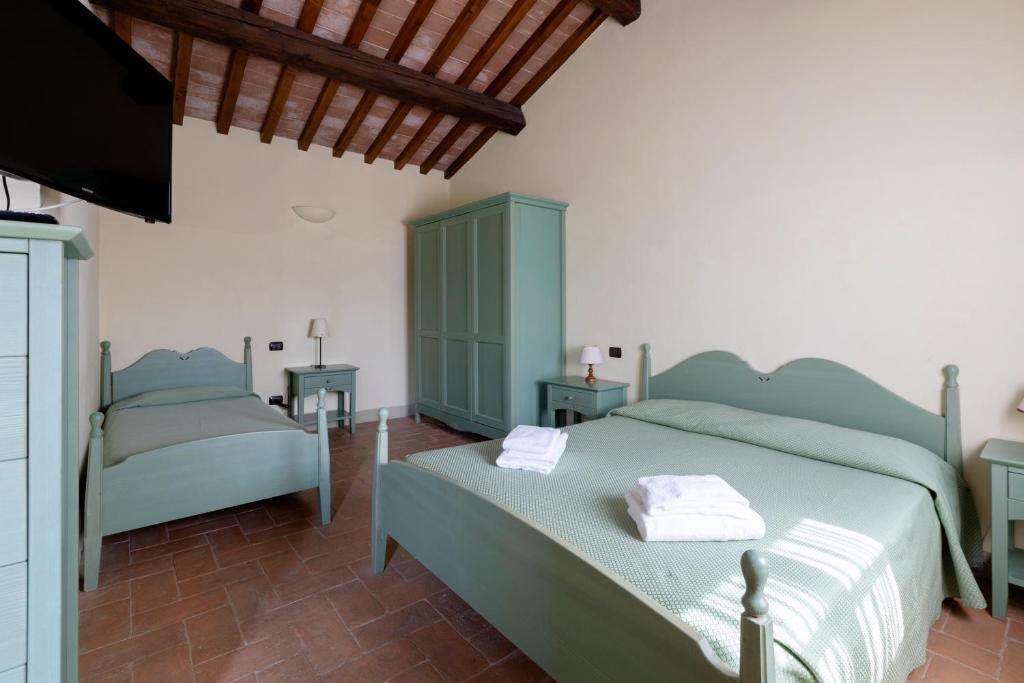 Łóżko lub łóżka w pokoju w obiekcie Agriturismo Villetta Di Monterufoli