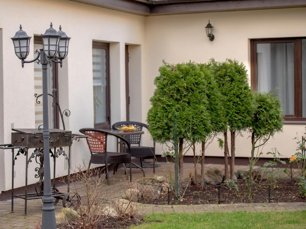 a porch with a table and chairs and a street light at Amphora in Ventspils