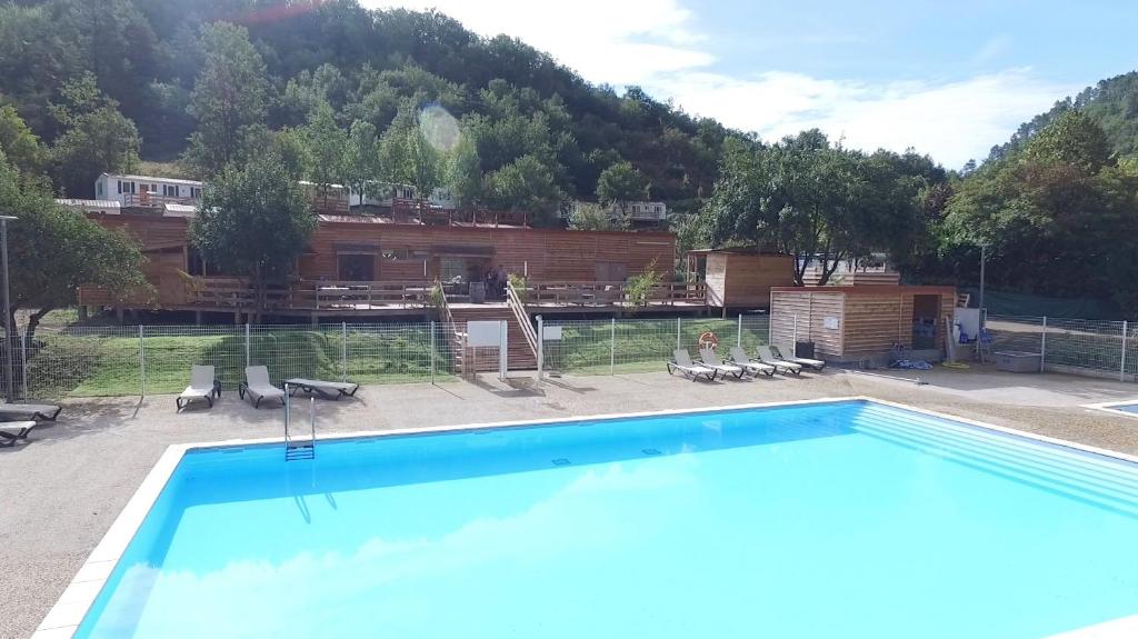 a large swimming pool in front of a building at Camping La Bernede in Rennes-les-Bains