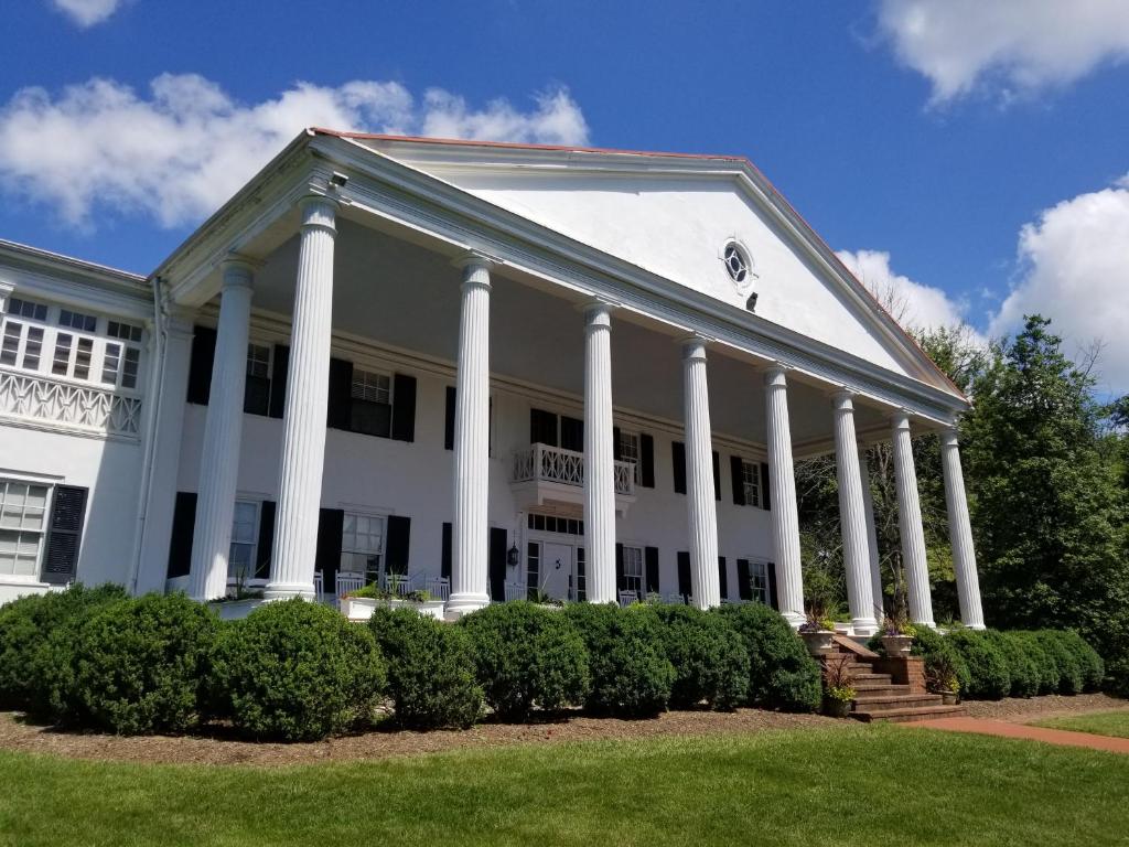 a large white building with white columns at Historic Rosemont Manor in Berryville