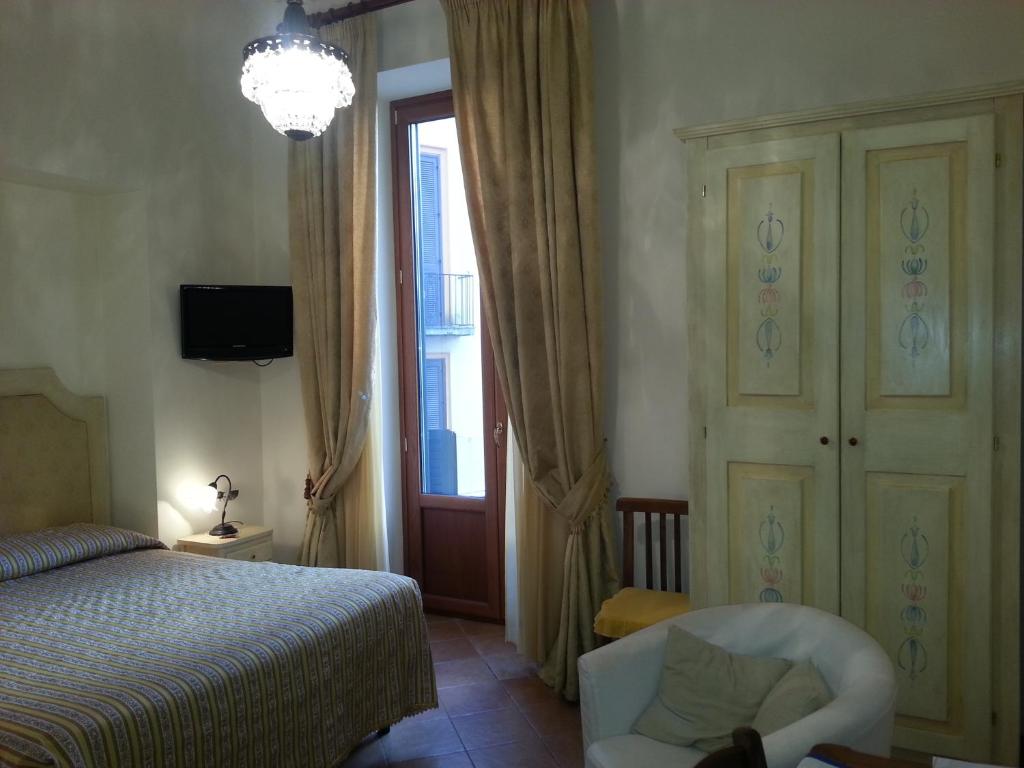 Postel nebo postele na pokoji v ubytování Divina House B&B