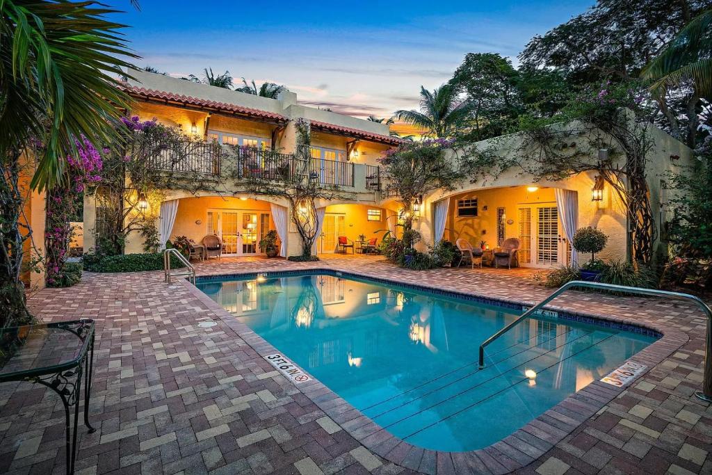 a swimming pool in front of a house at Grandview Gardens in West Palm Beach