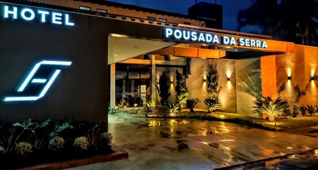a hotel with a sign on the side of it at Hotel Pousada da Serra in Maracaju