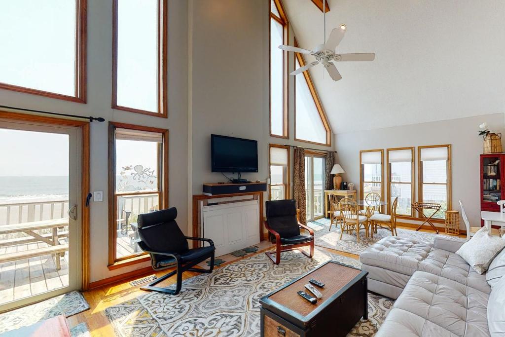 a living room with a couch and a tv at Westwind in Folly Beach