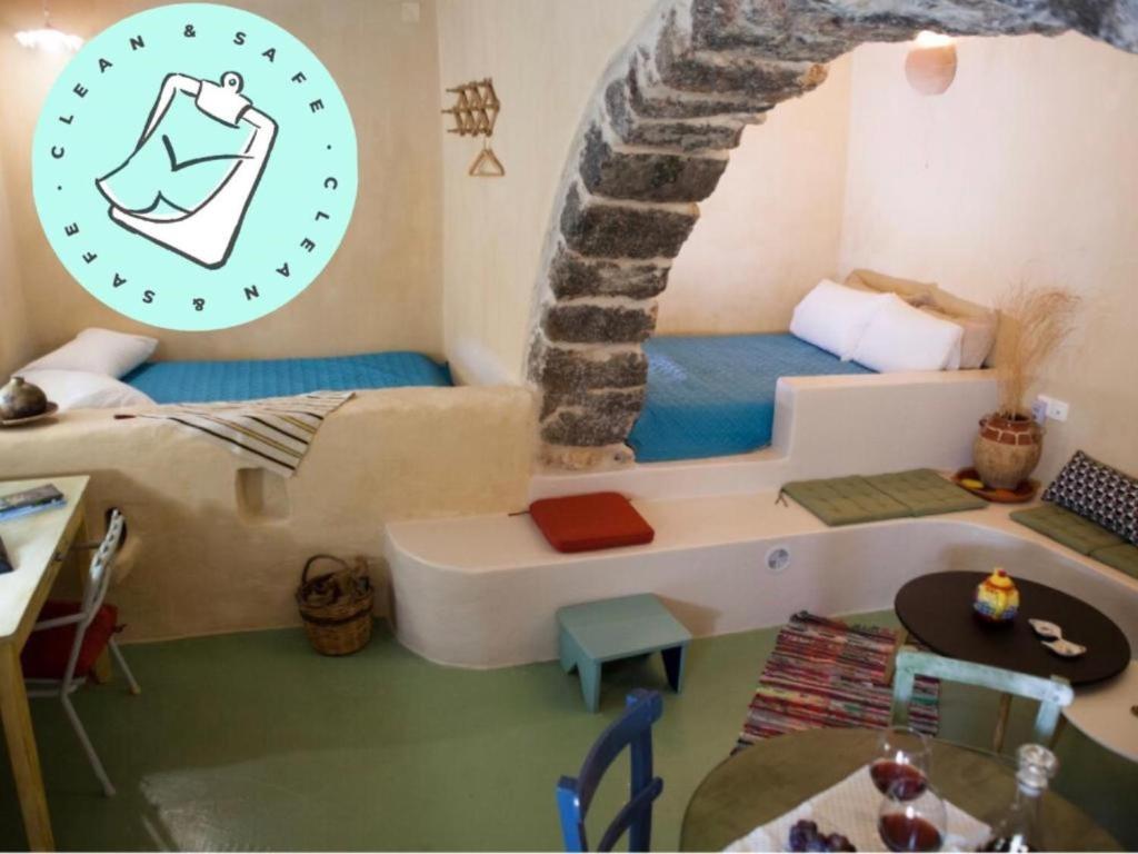 a small room with a bed and a staircase at Sitanos Anna House in Sítanos