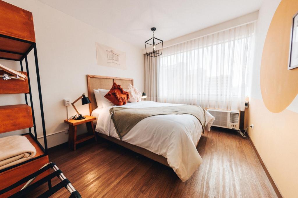 a bedroom with a bed and a window at Selina Posada Miraflores in Lima