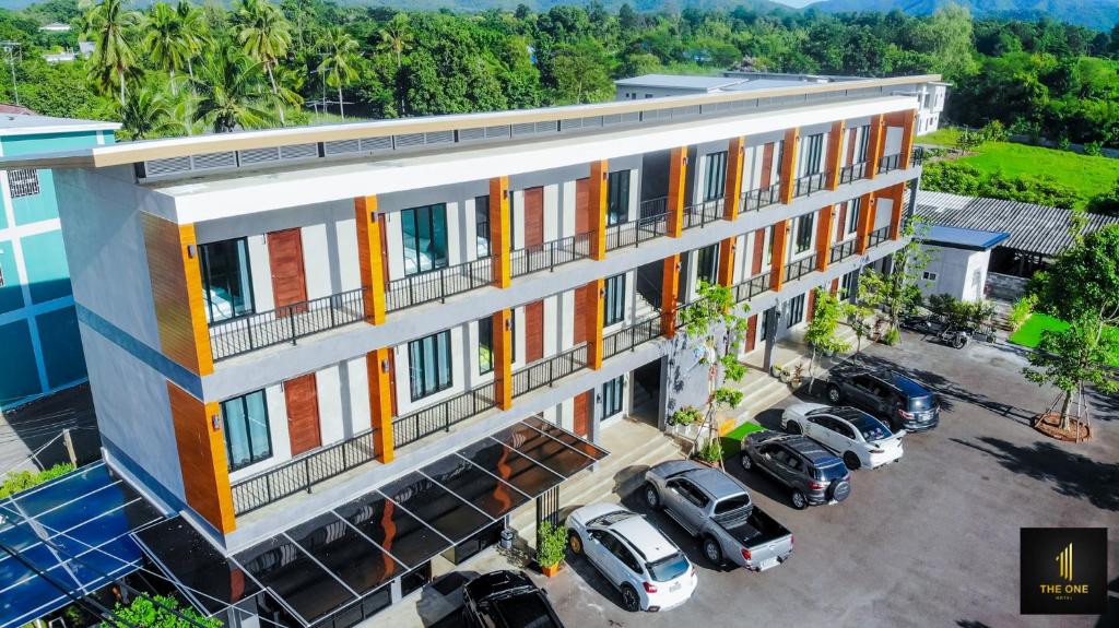 an overhead view of a building with cars parked in a parking lot at The one hotel สวนผึ้ง in Ratchaburi