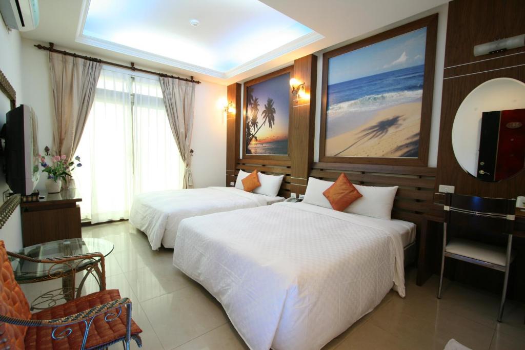Posteľ alebo postele v izbe v ubytovaní 墾丁貝殼灣旅店