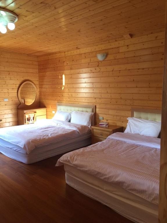 Postel nebo postele na pokoji v ubytování Yun Hsiang Zhan Chalet