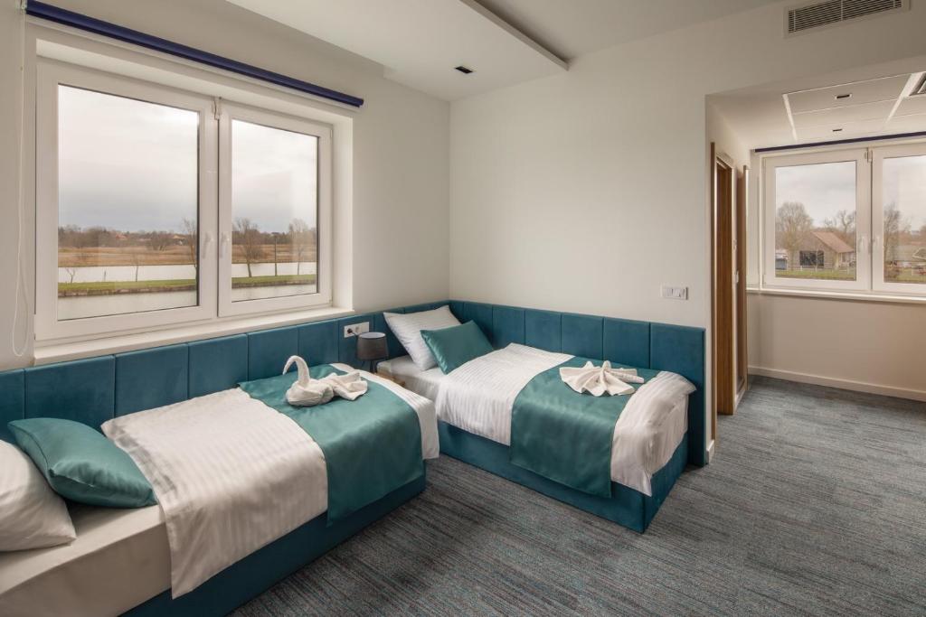 Posteľ alebo postele v izbe v ubytovaní Sziget Hotel