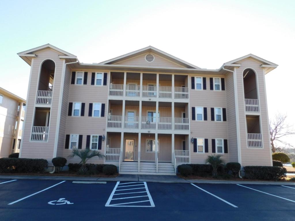 a large white building with a parking lot at Tilghman Shores D9 in Myrtle Beach