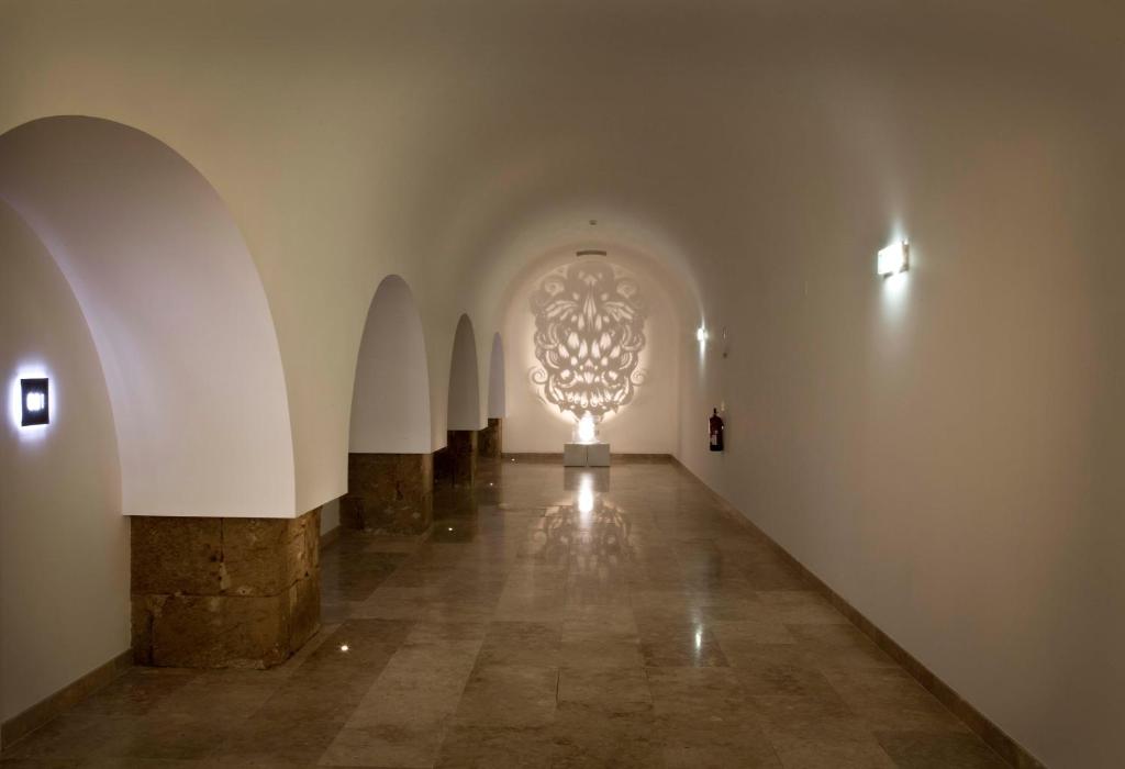 a hallway with a large chandelier in a building at Pestana Cidadela Cascais - Pousada & Art District in Cascais