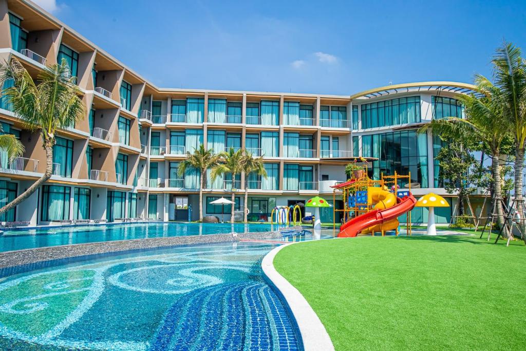 a resort pool with a slide and a playground at Elmas Cha Am Design Hotel in Cha Am