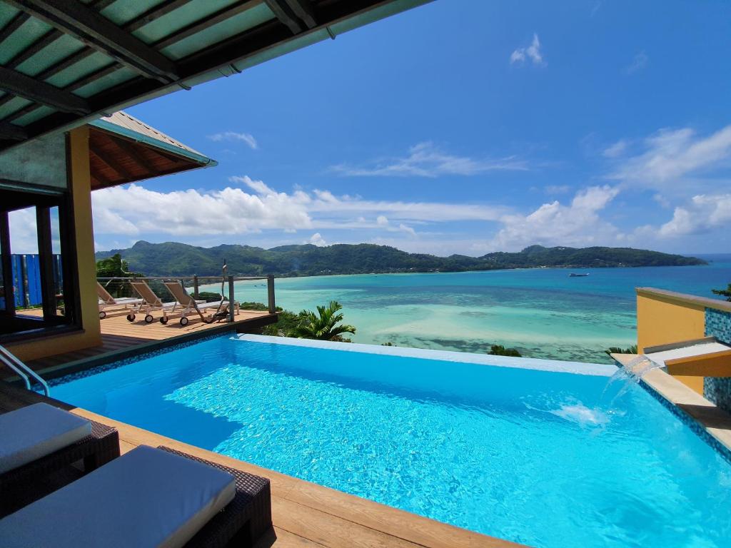 a swimming pool with a view of the ocean at VILLA KIKI Seychelles in Anse a La Mouche