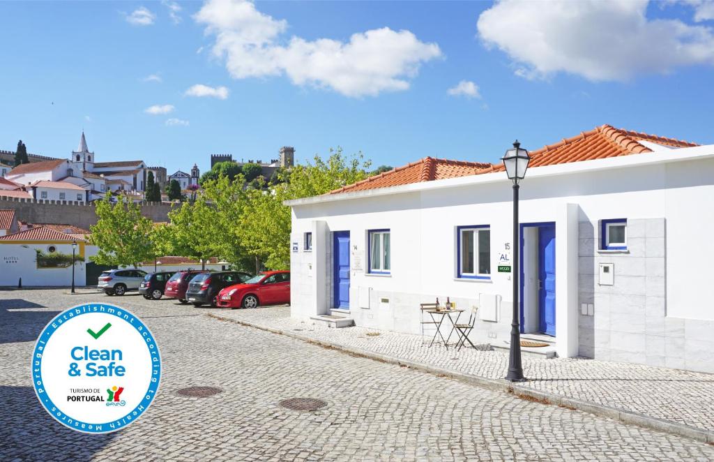 a white building with a sign that says clean and safe at Mood Lodging - Caldas & Ocean in Óbidos