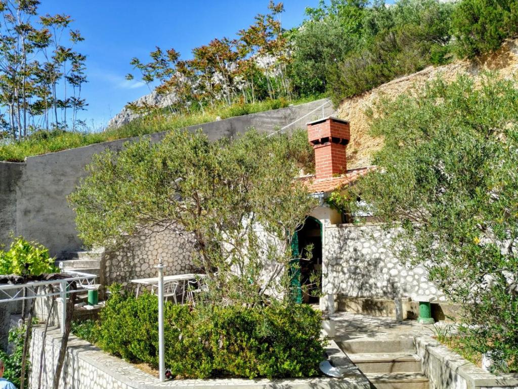 a house on the side of a hill at Apartments Asija in Brela