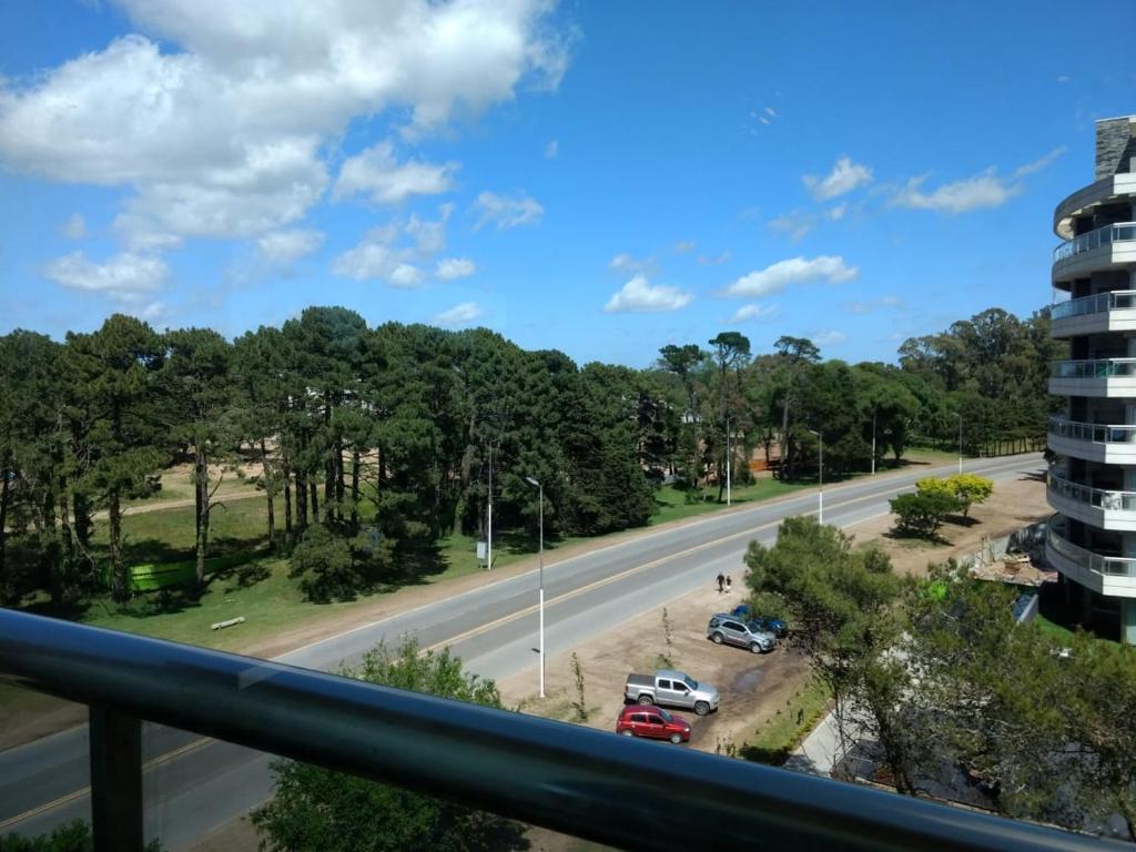 a view from a balcony of a road with trees at Semipiso de categoria in Pinamar