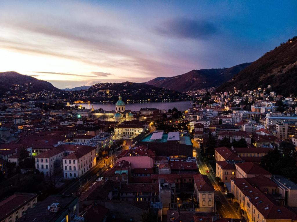 an aerial view of a city at night at Spazio 77 - The House Of Travelers in Como