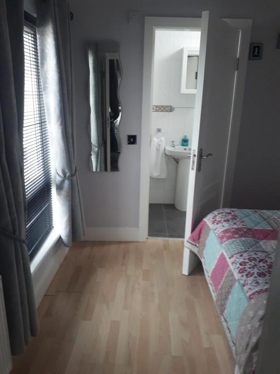 a bedroom with a bed and a bathroom at Ideal one bedroom appartment in Naas Oo Kildare in Naas