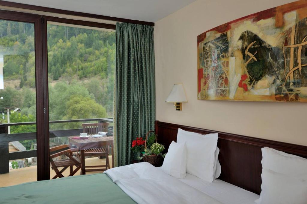 Postel nebo postele na pokoji v ubytování Zan Hotel