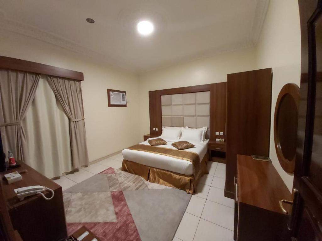 a hotel room with two beds and a bathroom at Reef Al-Hijrah Furnished Apartments in Al Madinah