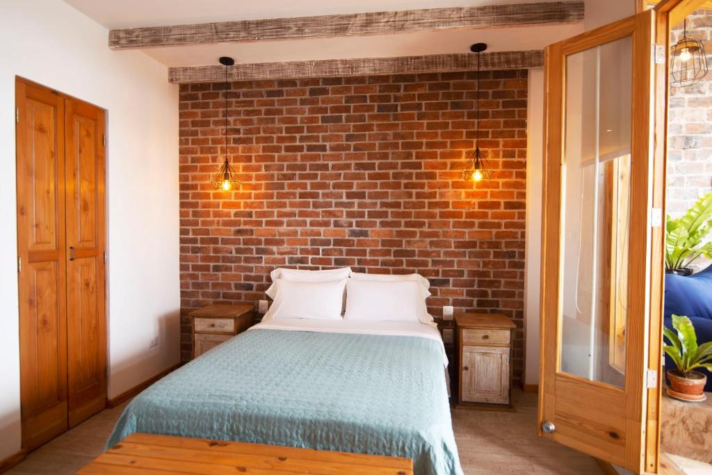 Postel nebo postele na pokoji v ubytování Kauhuhu Casa Hotel
