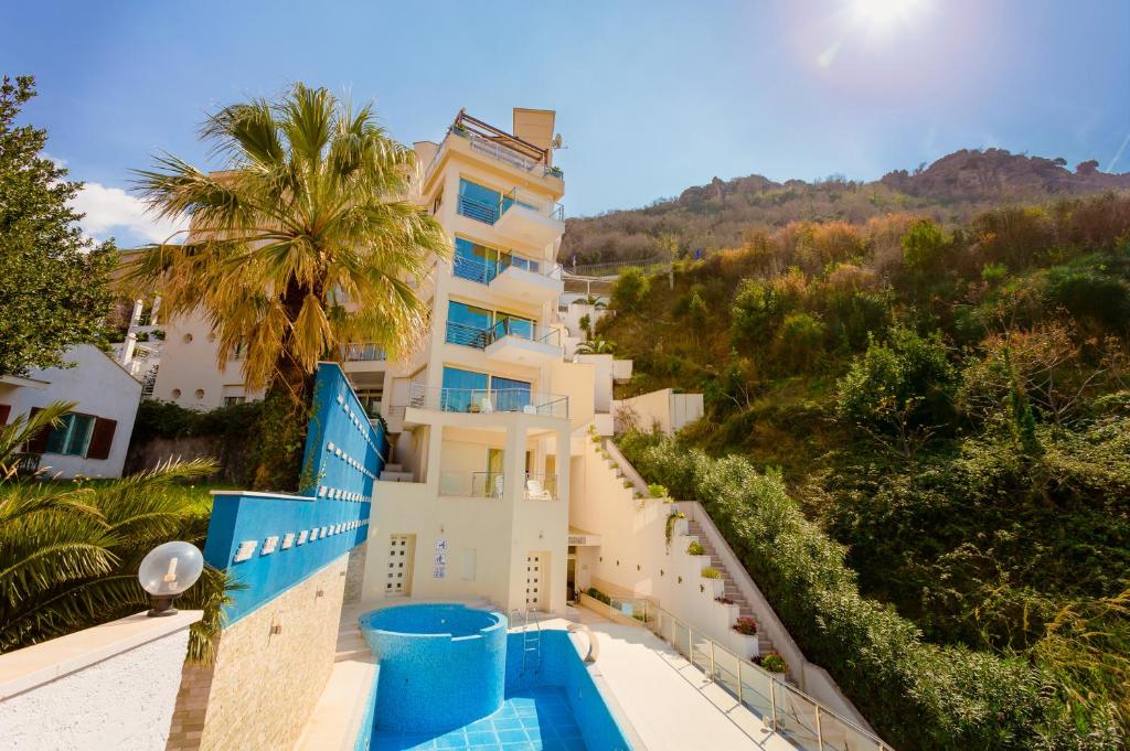 a view of a building with a swimming pool at Meridian Hotel in Budva